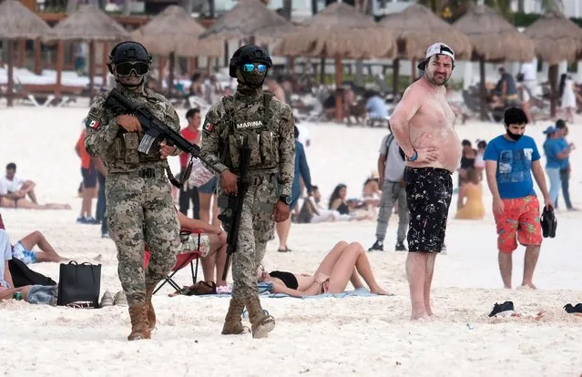 Members of the National Guard patrol a beach resort as part of the vacation security in the tourist zone in Cancun by the government of Quintana Roo, Mexico on December 5, 2021. (Photo by Paola Chiomate/Reuters)