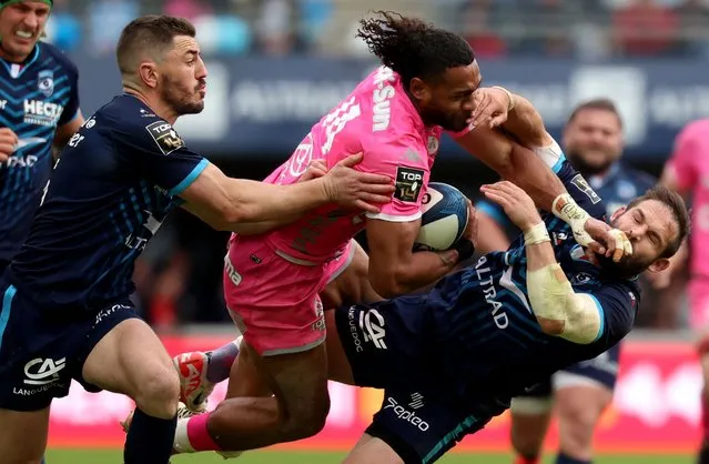 Stade Francais' Fijian wing Peniasi Dakuwaqa (C) fights for the ball with Montpellier's French full-back Anthony Bouthier (L) and Montpellier's South African scrum-half Cobus Reinach (R) during a French Top 14 rugby union match between Montpellier Herault Rugby (MHR) and  Stade Francais Paris at the GGL stadium in Montpellier, south-western France, on March 30, 2024. (Photo by Pascal Guyot/AFP Photo)