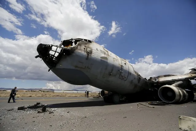 The wreckage of a Yemeni air force military transport aircraft is seen on the tarmac after the aircraft was destroyed by an air strike, at the international airport of Yemen's capital Sanaa, May 5, 2015. (Photo by Khaled Abdullah/Reuters)