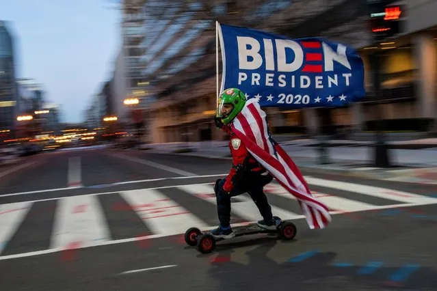 A supporter of U.S. President-elect Joe Biden rides his board near the White House ahead of Biden's inauguration, in Washington, U.S., January 19, 2021. (Photo by Eduardo Munoz/Reuters)