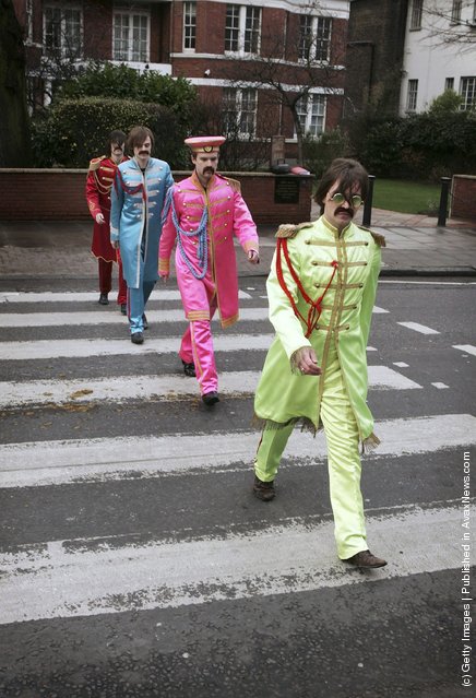 Actors play the part of the Beatles crossing a zebra crossing outside the Abbey Road studios