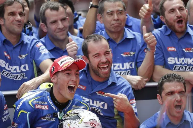 Aleix Espargaro of Spain and Team Suzuki MotoGP reacts after clocking the fastest time to take pole position for Sunday's Spanish Motorcycling in Montmelo, Spain, Saturday, June 13, 2015. The Catalunya Grand Prix will take place on Sunday in Montmelo. (AP Photo/Manu Fernandez)