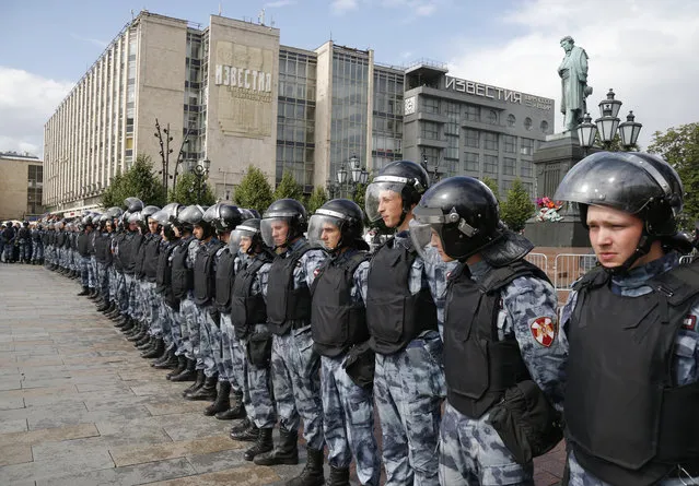 Police block a square during an unsanctioned rally in the center of Moscow, Russia, Saturday, August 3, 2019. Moscow police on Saturday detained nearly 90 people protesting the exclusion of some independent and opposition candidates from the city council ballot, a monitoring group said, a week after arresting nearly 1,400 at a similar protest. (Photo by Alexander Zemlianichenko/AP Photo)