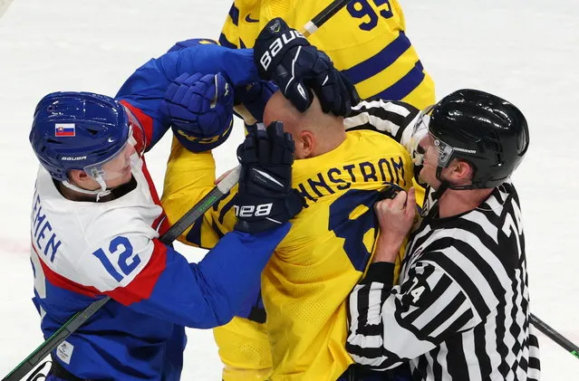Milos Kelemen of Slovakia and Theodor Lennstrom of Sweden clash during men's ice hockey at the 2022 Beijing Olympics, Wukesong Sports Centre in Beijing, China on February 11, 2022. (Photo by Brian Snyder/Reuters)