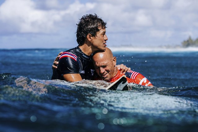 Seth Moniz and Kelly Slater, of the United States, embrace after Slater won the Billabong Pro Pipeline contest just short of his 50th birthday in Haleiwa, Hawaii, US on February 5, 2022. (Photo by Brent Bielmann/World Surf League via AP Photo)