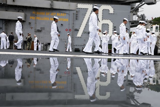 Crew of the U.S. navy aircraft carriers USS Ronald Reagan (CVN-76) rig a ship for the voyage at the U.S. navy's Yokosuka base Thursday, May 16, 2024, in Yokosuka, south of Tokyo. This is the ship's final departure from Yokosuka before transiting back to the United States. (Photo by Eugene Hoshiko/AP Photo)