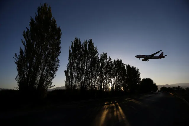 A TAM Airlines plane lands at Santiago International Airport, Chile March 30, 2017. (Photo by Ivan Alvarado/Reuters)