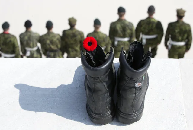 Canadian soldiers stand in a line in front of a black boot with a red poppy, representing the fallen, at the WWI Canadian National Vimy Memorial in Givenchy-en-Gohelle, France on Friday, April 7, 2017. Commemoration ceremonies will take place on Sunday at the memorial to honor Canadian soldiers who were killed or wounded during the Battle of Vimy Ridge in April 1917. (Photo by Virginia Mayo/AP Photo)