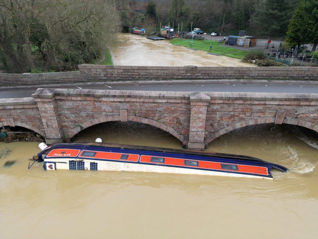 A narrow boat lays next to a road bridge over the River Soar after being swept away by flooding in the aftermath of Storm Henk on January 05, 2024 in Barrow on Soar, United Kingdom. Days of heavy rainfall have exacerbated conditions in already saturated areas in the wake of Storm Henk, which caused widespread damage across parts of the UK, with winds of more than 90mph sweeping across some regions. (Photo by Christopher Furlong/Getty Images)