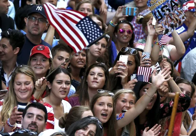 Fans pack the sidewalks to view the U.S. women's soccer team riding in floats during the ticker tape parade up Broadway in lower Manhattan to celebrate their World Cup final win over Japan in New York, July 10, 2015. (Photo by Mike Segar/Reuters)