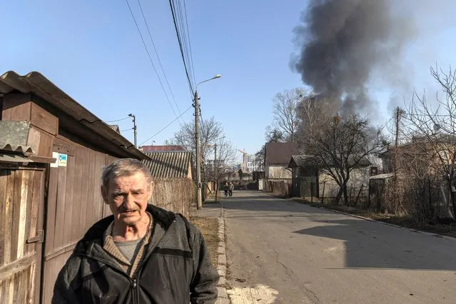 A man walks at a residential district that was damaged by shelling, as Russia's invasion of Ukraine continues, in Kyiv, Ukraine on March 23, 2022. (Photo by Marko Djurica/Reuters)