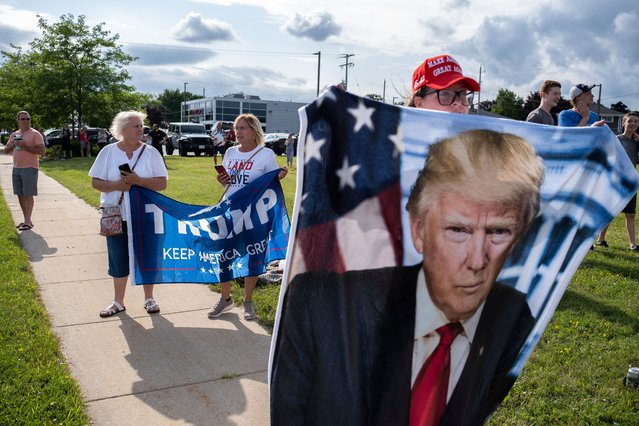 Supporters of Republican presidential candidate, former U.S. President Donald await his arrival at Milwaukee Mitchell International Airport on July 14, 2024 in Milwaukee, Wisconsin. Law enforcement officials began final preparations on the eve of the Republican National Convention where Trump is expected to formally receive the GOP nomination for the 2024 U.S. Presidential election. Trump suffered minor injuries during a campaign rally on on July 13 in Butler, Pennsylvania after a gunman opened fired, killing one person and injuring two critically. (Photo by Jim Vondruska/Getty Images)