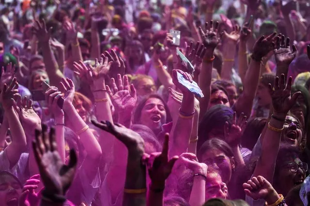 People gesture and dance as they take part in the Color Festival on May 7, 2017 at Kadikoy district, in Istanbul, Turkey. (Photo by Ozan Kose/AFP Photo)