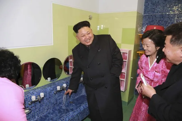 North Korean leader Kim Jong Un (L) visits the Pyongyang Baby Home and Orphanage on New Years Day in this photo released by North Korea's Korean Central News Agency (KCNA) in Pyongyang January 2, 2015. (Photo by Reuters/KCNA)