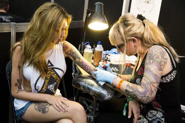 A woman gets tattooed at The Great British Tattoo Show at Alexandra Palace on May 24, 2014 in London, England. (Photo by Tristan Fewings/Getty Images for Alexandra Palace)