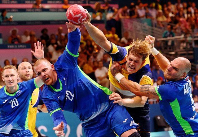 Matej Gaber of Slovenia, Karl Wallinius of Sweden and Borut Mackovsek of Slovenia during the men's handball preliminary round on July 31, 2024. (Photo by Bernadett Szabo/Reuters)