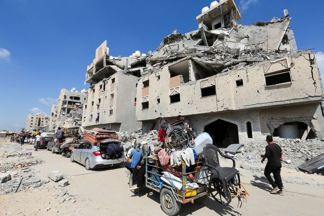 Displaced Palestinians make their way as they flee Hamad City following an Israeli evacuation order, amid Israel-Hamas conflict, in Khan Younis in the southern Gaza Strip on August 11, 2024. (Photo by Hatem Khaled/Reuters)