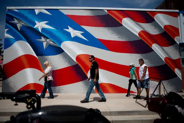 Bikers walk along Main Street in downtown Custer while participating in the annual Sturgis Motorcycle Rally in South Dakota on August 3, 2015. (Photo by Kristina Barker/Reuters)