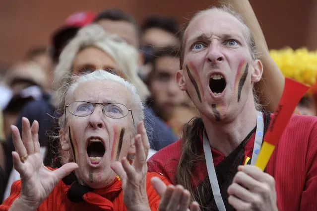 Belgian supporters react as they watch a broadcast of Belgium's 2014 World Cup quarter-final soccer match against Argentina in Brazil, on a screen at the King Baudouin Stadium in Brussels July 5, 2014. (Photo by Eric Vidal/Reuters)