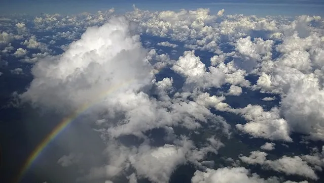 A rainbow appears as fluffy clouds are seen from my aeroplane window over the Amazon in Brazil during the 2014 World Cup June 23, 2014. In a project called “On The Sidelines” Reuters photographers share pictures showing their own quirky and creative view of the 2014 World Cup in Brazil. (Photo by Dylan Martinez/Reuters)