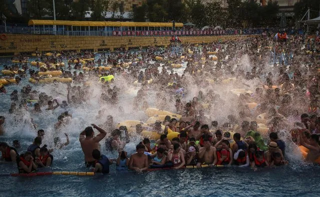 Tourists crowd a water park in Wuhan city, central China's Hubei province on July 15, 2017. (Photo by Imaginechina/Rex Features/Shutterstock)