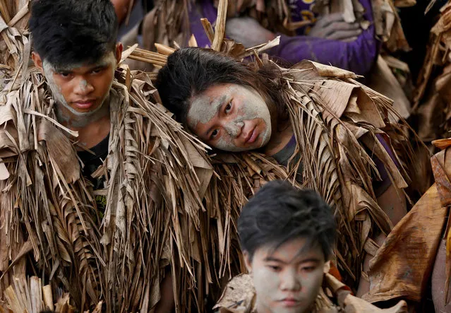 Villagers, donning capes mostly of dried banana leaves and covered in mud, attend a mass in a bizarre annual ritual to venerate their patron saint, John the Baptist, Friday, June 24, 2016 at Bibiclat, Aliaga township, Nueva Ecija province in northern Philippines. (Photo by Bullit Marquez/AP Photo)