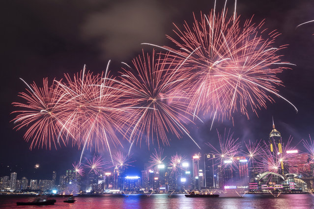 Fireworks explode over Victoria Harbour to mark the 75th National Day of the People's Republic of China, at Tsim Sha Tsui in Hong Kong, Tuesday, October 1, 2024. (Phoot by Chan Long Hei/AP Photo)