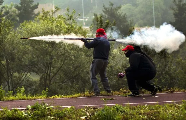 Miners fire handmade rockets at riot police near the mine El Soton  near Oviedo, Spain on June 15, 2012