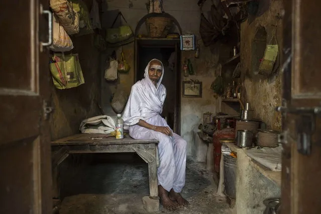 Savitri, an 80-year-old widow, poses for a photograph inside her room at Mumukshu Bhavan (Home of the Ailing) in Varanasi, in the northern Indian state of Uttar Pradesh, June 19, 2014. (Photo by Danish Siddiqui/Reuters)