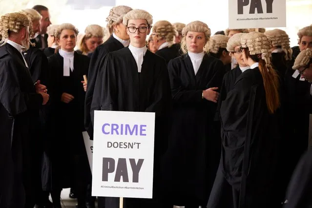 Criminal barristers from the Criminal Bar Association (CBA), which represents barristers in England and Wales, outside the Old Bailey, central London on Monday, June 27, 2022, on the first of several days of court walkouts by CBA members in a row over legal aid funding. (Photo by Christopher Thomond/The Guardian)
