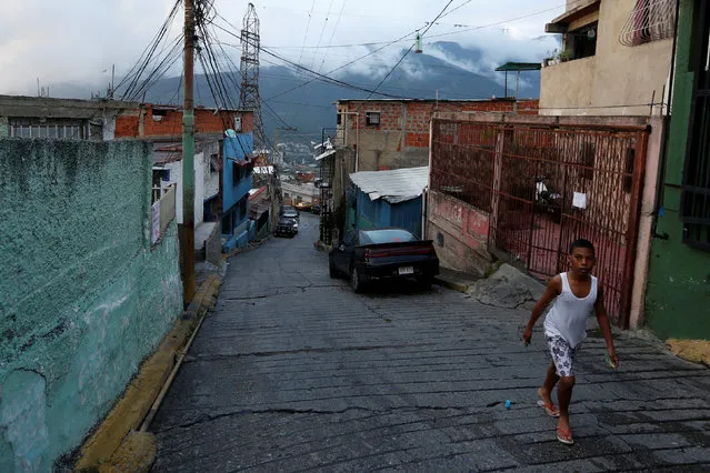 A boy walks on the street in a low income neighborhood in Caracas, Venezuela July 8, 2016. (Photo by Carlos Jasso/Reuters)