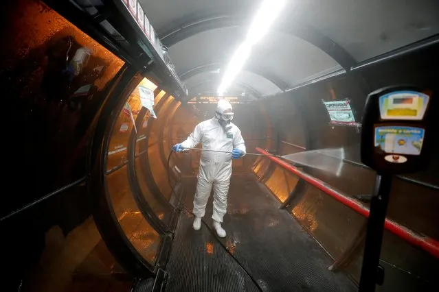 A worker disinfects a bus stop during the outbreak of the coronavirus disease (COVID-19), in Curitiba, Brazil, April 2, 2020. (Photo by Rodolfo Buhrer/Reuters)