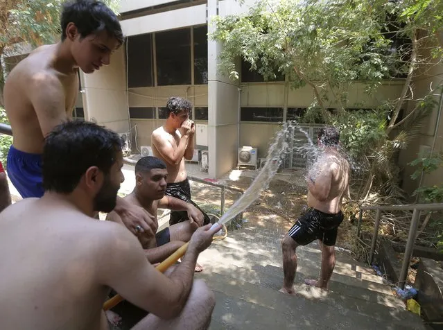 Followers of Shiite cleric Muqtada al-Sadr cool off inside the green zone, amid a sit-in inside the parliament building, in Baghdad, Iraq, Tuesday, August. 2, 2022. (Photo byAnmar Khalil/AP Photo)