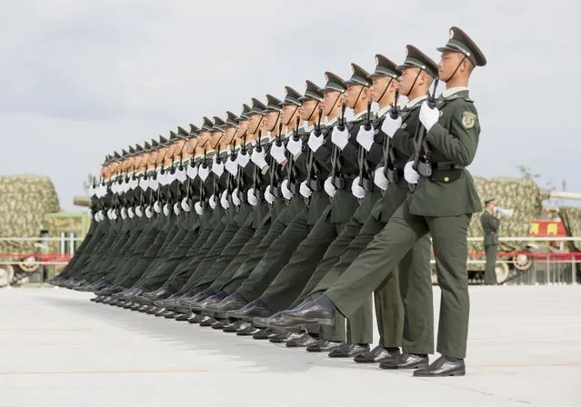 Soldiers of China's People's Liberation Army march with their weapons during a training session for a military parade to mark the 70th anniversary of the end of World War Two, at a military base in Beijing, China, September 1, 2015. (Photo by Reuters/Stringer)