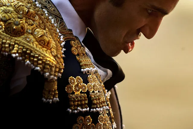Portuguese bullfighter Manuel Dias Gomes reacts as he watches a bull die during a bullfight in Madrid, Spain, Sunday, June 29, 2014. Bullfighting is an ancient tradition in Spain. (Photo by Daniel Ochoa de Olza/AP Photo)