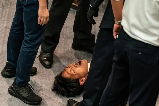 Pro democracy lawmaker Eddie Chu is surrounded by security during a scuffle with pro Beijing lawmakers at the House Committee's election of chairpersons, presided by pro-Beijing lawmaker Chan Kin Por at the Legislative Council on May 18, 2020 in Hong Kong, China. Pro-democracy legislators were dragged out of the chamber by security guards as the two camps fought to control the House Committee which has been at a standstill for months. (Photo by Anthony Kwan/Getty Images)