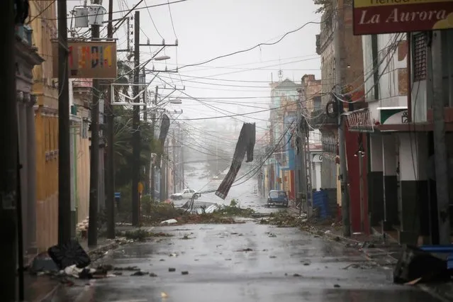 Debris hang on the street in the aftermath of Hurricane Ian's passage through Pinar del Rio, Cuba on September 27, 2022. (Photo by Alexandre Meneghini/Reuters)