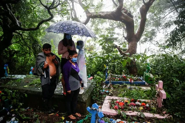 Relatives take part in the funeral of Fredy Amilcar Gomez Blanco and Jason Eulises Gomez Gomez, who died after they were dragged by river flooding caused by Tropical Storm Amanda, in Santa Tecla, El Salvador on June 4, 2020. (Photo by Jose Cabezas/Reuters)