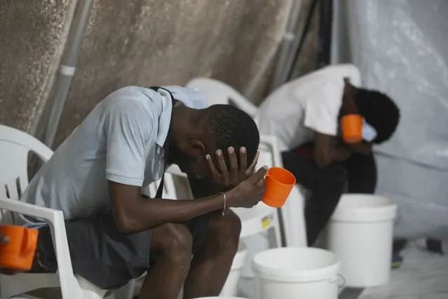 Patients with cholera symptoms sit in an observation center at a cholera clinic run by Doctors Without Borders in Port-au-Prince, Haiti, Friday, October 7, 2022. (Photo by Joseph Odelyn/AP Photo)
