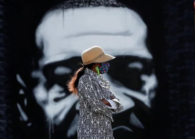 A visitor looks at a memorial at the site of the arrest of George Floyd, who died while in police custody, in Minneapolis, Minnesota, U.S. June 14, 2020. (Photo by Eric Miller/Reuters)