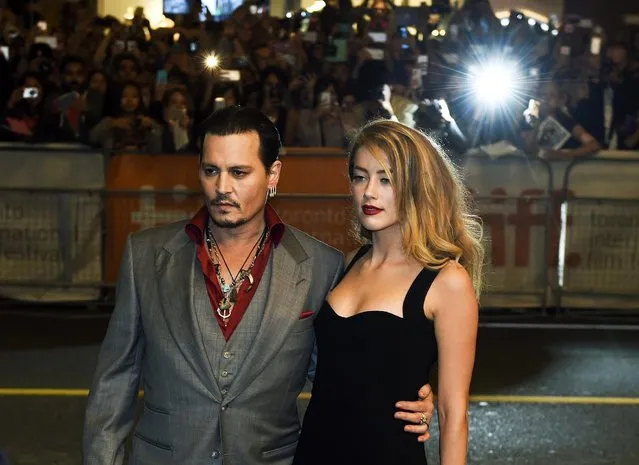 Actor Johnny Depp and wife Amber Heard pose for photographs on the red carpet for the new movie “Black Mass” during the 2015 Toronto International Film Festival on Monday, September 14, 2015. (Photo by Nathan Denette/The Canadian Press via AP Photo)