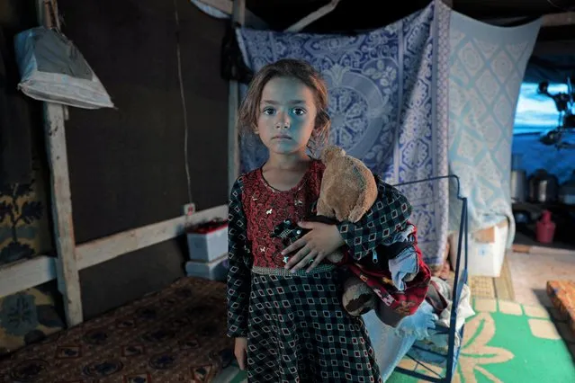 Rawan al-Aziz, a 6-year-old Syrian displaced child, from Southern Idlib countryside, poses for a picture in a tent at Atmeh camp, near the Turkish border, Syria on June 19, 2020. (Photo by Khalil Ashawi/Reuters)