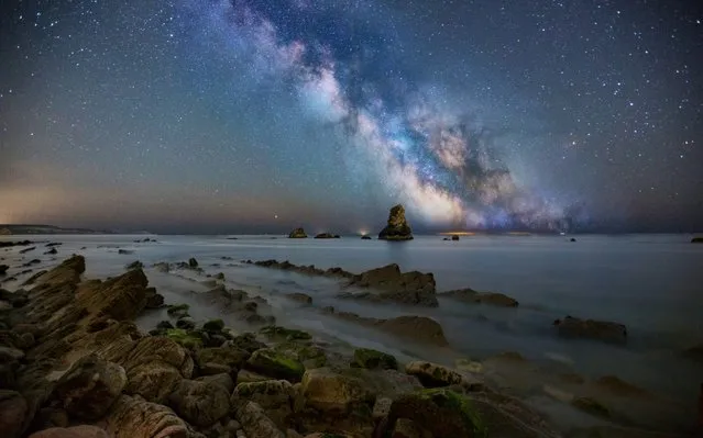 These stunning shots, by landscape photographer Matt Pinner, capture the full majesty of the milky way galactic core suspended over the rugged Dorset coastline on May 2020. (Photo by MattPinner/BNPS)