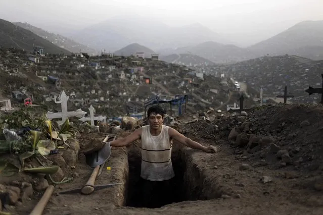 FILE- In this Sept. 9, 2013 file photo, grave digger Juan Luis Cabrera takes a break from his work at the "Nueva Esperanza" cemetery in Lima, Peru. (AP Photo/Rodrigo Abd, File)