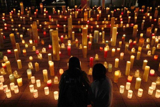 This photo taken on March 10, 2025 shows candles at a memorial for the victims on the eve of 14th anniversary of the 2011 earthquake and tsunami disaster in Futaba, Fukushima Prefecture. (Photo by JIJI Press/AFP Photo)