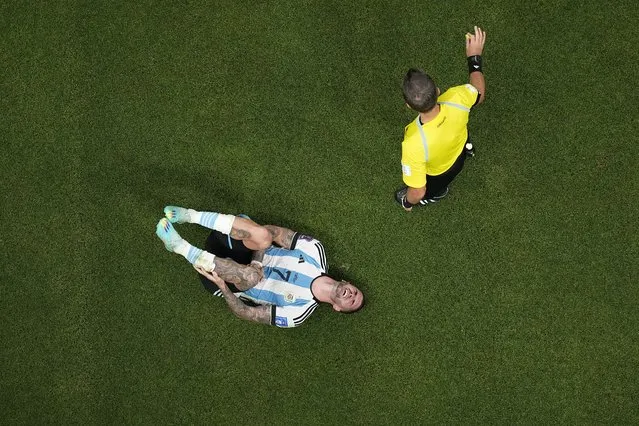 Argentina's Rodrigo De Paul reacts next to referee Daniele Orsato of Italy during the World Cup group C soccer match between Argentina and Mexico, at the Lusail Stadium in Lusail, Qatar, Saturday, November 26, 2022. (Photo by Pavel Golovkin/AP Photo)