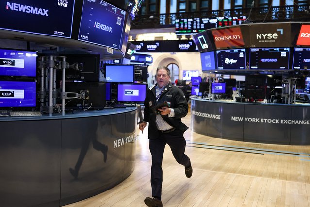 A trader runs on the floor of the New York Stock Exchange (NYSE) at the opening bell in New York City on April 3, 2025. Wall Street stocks sank in early trading on April 3,2025, joining a global equity selloff after President Donald Trump's latest tariff announcement exacerbated worries about a trade war and global economic downturn. (Photo by Charly Triballeau/AFP Photo)