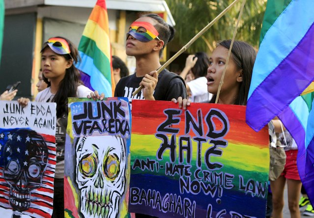 Members of the Lesbians, Gays, Bisexuals and Transgenders (LGBT) community march to mark the first year death anniversary of Filipino transgender Jennifer Laude, in Makati City, Metro Manila October 11, 2015. The Bahaghari LGBT organisation said the march sought to renew public awareness on discrimination and hate crimes against members of the LGBT community. (Photo by Janis C. Alano/Reuters)