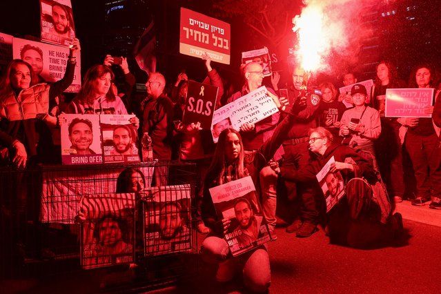Relatives and supporters of Israeli hostages held in Gaza since the October 7 attacks by Hamas militants, hold placards during a demonstration in Tel Aviv, on March 26, 2024, amid the ongoing conflict in the Gaza Strip between Israel and the Palestinian militant Hamas movement. (Photo by Jack Guez/AFP Photo)
