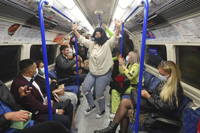 People ride a Northern Line train in London after the 10 p.m. curfew pubs and restaurants are subject to in order to combat the rise in coronavirus cases in England, on Saturday October 3, 2020. (Photo by Victoria Jones/PA Wire via AP Photo)